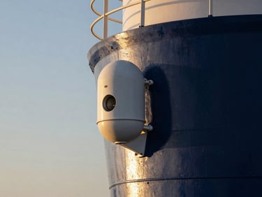Sleek maritime security hardware mounted on a vessel tower, golden hour lighting, premium editorial photography.