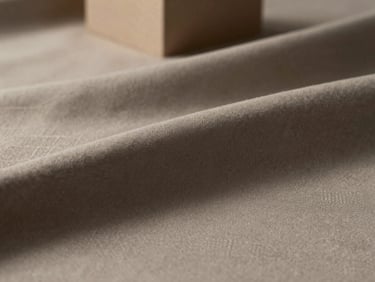 Texture shot of matte-finished cotton fabric, subtle geometric weave, soft studio light, focus on fabric hand.