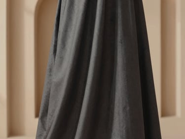 Close-up of a perfectly draped wash & wear shalwar kameez fabric, soft natural light, minimalist background, architectural lines.