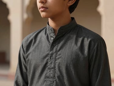 Young boy in a charcoal kurta, close-up on collar stitching, soft side-shadows.