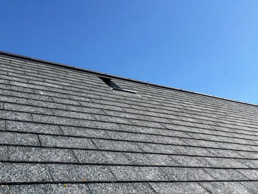 Roofing technician inspecting a shingle roof at Tyler, TX