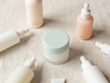 Clean, minimalist flat lay of natural skincare products on a neutral linen background, soft pastel tones, bright natural daylight.