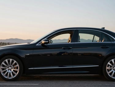 Side profile of a polished black executive sedan parked under soft morning light in Boise, clean lines, shallow depth of field, 35mm
