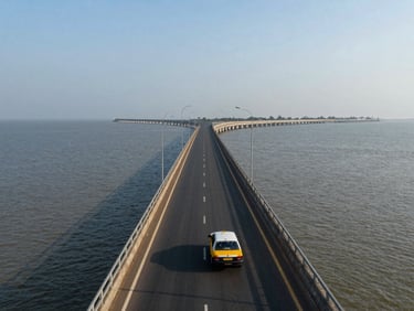 Wide panoramic view of Mumbai's Bandra-Worli sea link at daytime, a cab visible on the bridge road, operational transport framing, documentary light