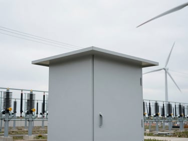 Modern step-up substation enclosure designed for wind farms, clean technical lines, overcast sky, 35mm