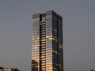 Stunning modern glass penthouse skyscraper in Itaim Bibi at twilight, glowing warm interior lights, deep graphite sky.