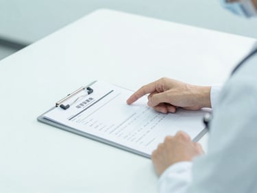 Close-up of a medical consultation, a doctor pointing to a clinical chart on a clean white desk, sterile teal tones