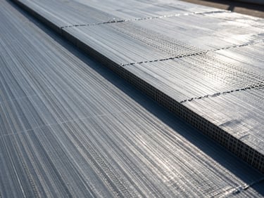 Close-up of a drainage composite sheet showing the geonet core laminated with non-woven geotextile fabric, technical cross-section.