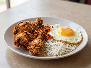 A plate of Nasi Lemak with fried chicken, sambal, and egg, on a textured table with warm natural light, appetizing close-up