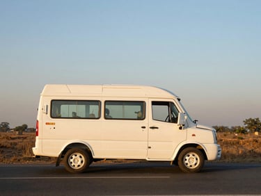 A clean white 12-seater Tempo Traveller on a wide open road near Mathura, soft golden hour light, clean side profile view