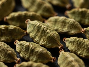 Macro shot of premium green cardamom pods, showcasing clean ridges and vibrant natural color under moody, atmospheric side lighting.