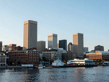 Panoramic view of Baltimore's Inner Harbor at dawn, showing commercial buildings and infrastructure, crisp editorial photography, bright natural daylight, deep navy and cool gray tones, sharp focus, 35mm