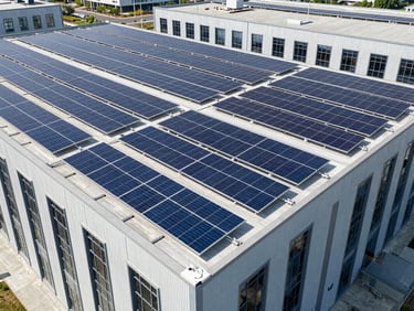 Wide-angle drone shot of a large commercial building with extensive Sunicorn Solar panel installation, bright natural sunlight, crisp architectural framing, 35mm