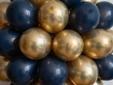 Macro shot of organic balloon clusters showing contrasting matte navy and high-shine metallic gold textures, sharp focus, dramatic studio lighting
