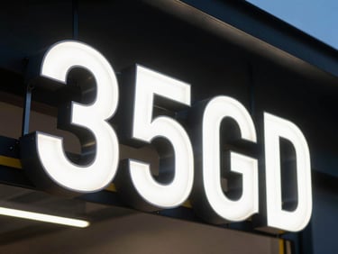 Close-up of a custom fabricated LED channel letter sign under high-contrast twilight lighting, showcasing clean metal joins and pristine acrylic face