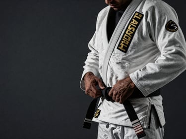 Dramatic side-lighting on a Brazilian Jiu-Jitsu practitioner tying their black belt, gritty athletic tone, high-contrast dark charcoal background, 35mm lens