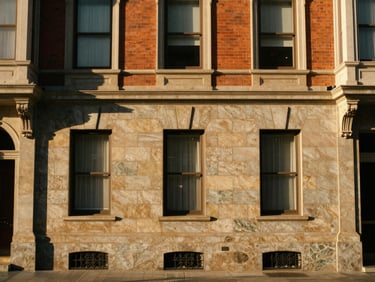 Classic San Francisco brick and stone facade on Montgomery Street, warm golden hour sunlight, clean lines, medium format film.