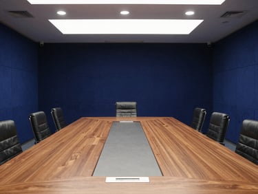 Wide shot of a secure government conference room in Islamabad, large custom timber table, navy blue acoustic panels, professional lighting
