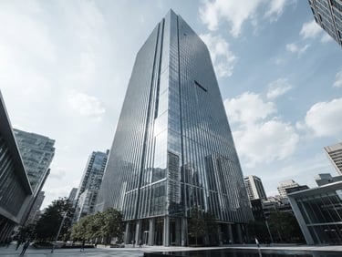 Wide-angle architectural exterior of a modern commercial high-rise with flawless structural glazing, bright natural daylight, sharp glass reflections, desaturated cool tones