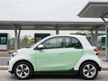 A sleek compact economy car parked near a contemporary transit hub under bright overcast skies
