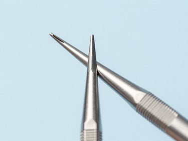 Macro close-up of a beveled surgical scalpel tip reflecting bright studio light, sterile blue background, high-key lighting.