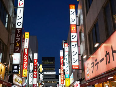 Vibrant Tokyo streetscape at night, towering neon signs, high-contrast deep indigo sky, sharp 35mm focus