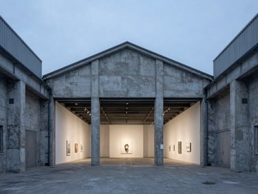 Straight-on architectural composition of an industrial warehouse interior converted into an art gallery, cool daylight, concrete textures, sharp focus.