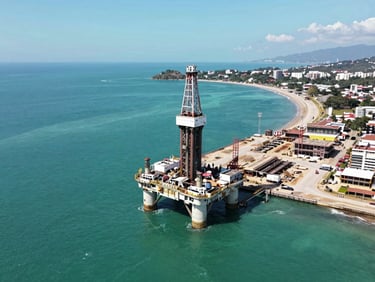 Aerial drone view of active luxury port construction in Limon Costa Rica, bright coastal daylight, heavy high-tech marine drill rigs, deep turquoise sea water, wide angle perspective