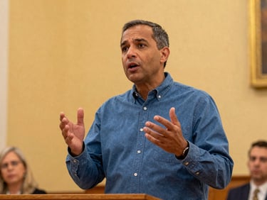 A pastor preaching with expressive hands, warm golden sanctuary light
