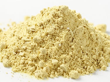 Macro studio shot of pale yellow lemon powder and tamarind powder, bright high-key lighting, sharp focus.