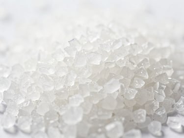 Close-up macro shot of white chondroitin sulfate crystals, bright natural daylight, soft shadows, clean minimalist product shot