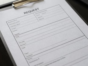 Close overhead shot of an official maintenance request form on a desk under fluorescent institutional lighting, blank fields visible, crisp paper texture