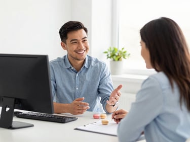 A friendly IT consultant talking to a business owner in a bright, modern Iowa office, soft daylight, 35mm