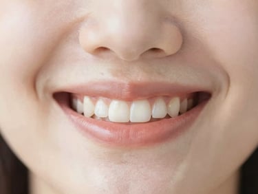 Macro shot of a healthy, natural smile, soft lighting, warm tones, clean clinical aesthetic