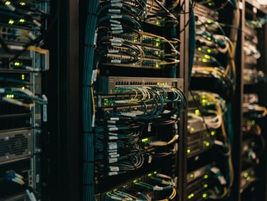 Close-up of clean telecommunication racks with subtle green and gold LED glows, warm editorial photography, shallow depth of field, 35mm