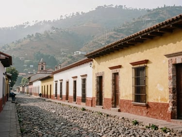 Charming cobblestone street of Real del Monte, colorful rustic facades, soft overcast daylight, authentic Mexican mountain town, 35mm film style