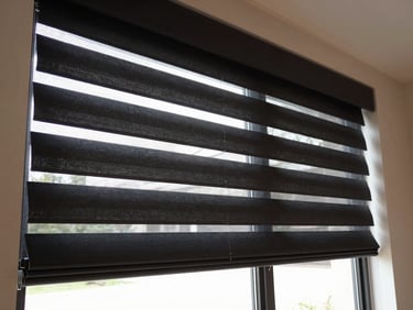 Interior shot of a large residential window with automated shades smoothly descending, natural light streaming through, clean interior lighting, deep charcoal and amber tones, high detail, 35mm