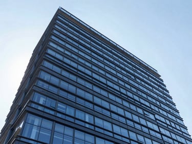 Wide-angle architectural photography of a modern corporate building facade in Imbituva, clean straight lines, bright daylight, deep corporate blue tones