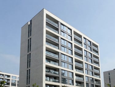 Contemporary residential building with clean concrete and glass facade, bright natural light, professional architectural shot