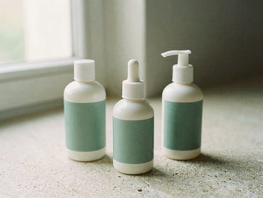 Three ceramic skincare bottles on a textured stone surface, sage green accents, soft natural lighting, medium format film