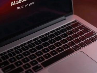Close-up of a sleek, dark-themed corporate website on a high-end laptop, showing elegant typography and subtle red accents, low-key dramatic lighting.