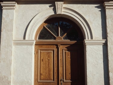 Warm late-afternoon sun hitting a classic arched doorway in Athens, elegant architectural detail, medium format film.