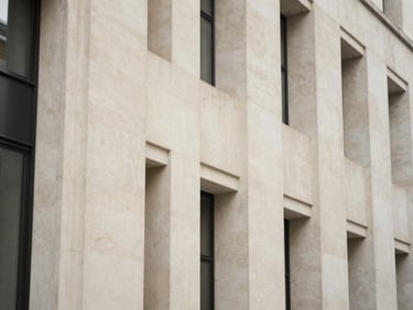 Macro architectural detail of a modern limestone facade in London, soft natural daylight, muted sophisticated tones.