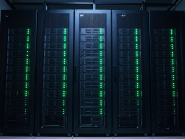 Abstract server rack patterns with green LED indicators blinking in a dark server room, symmetrical wide perspective, low-key cool-blue ambient light.