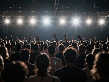 Cinematic shot of a high-energy event, dynamic lighting, crowd in motion, 16:9 aspect ratio, moody backlighting, anamorphic lens flares