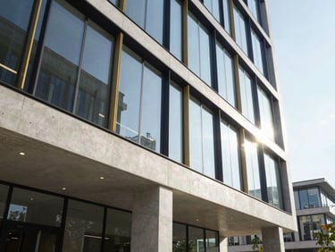 Architectural detail of a modern concrete and glass office lobby, bright morning sun