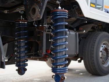 Detailed macro shot of heavy-duty truck suspension air spring bellows, clean industrial setting, high contrast