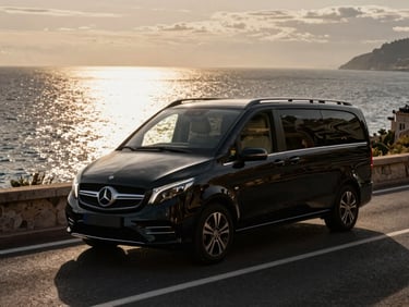 Exterior shot of a black Mercedes-Benz V-Class driving along the coastal road between Nice and Monaco, dramatic low-key lighting, sea in the background, anamorphic lens