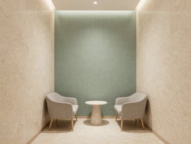 Minimalist interior of a clinical consultation room, warm travertine walls, soft sage green linen accent, elegant modern furniture, diffused lighting
