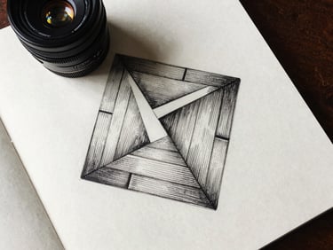 Overhead flat-lay of a geometric ink drawing on heavy cotton paper, natural side-lighting, sharp dark shadows, scholarly study setting.